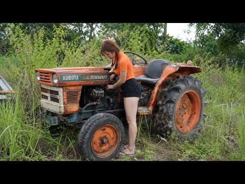 The girl repaired and started up the agricultural tractor that had been out of service for 5 years.